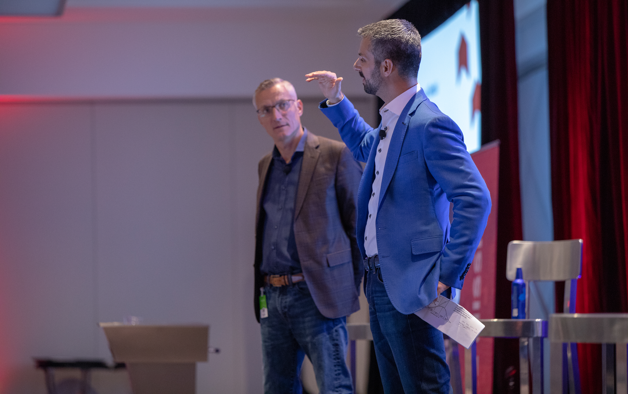meetleadership1 CEO of Fleet Complete speaking on stage beside Marketing VP.