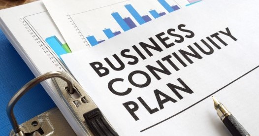 Business continuity plan in a blue folder.
